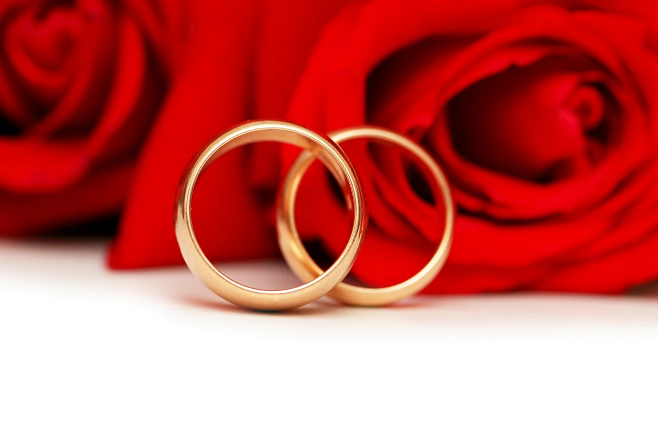 Обручальные кольца на Красном фоне. Поздравление с годовщиной свадьбы